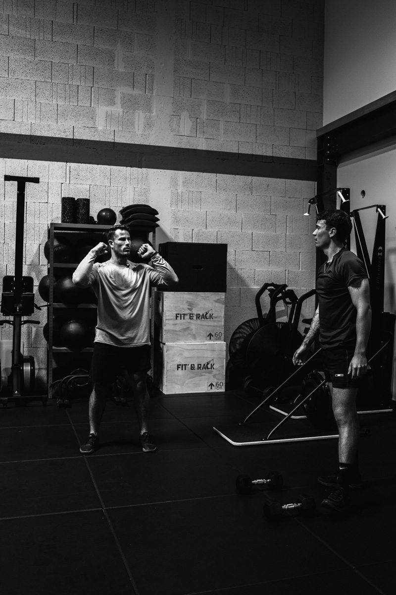 Le coach corrigeant la position d'un athlète
